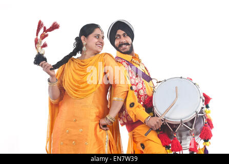 Sikh bhangra dancers standing back to back Stock Photo