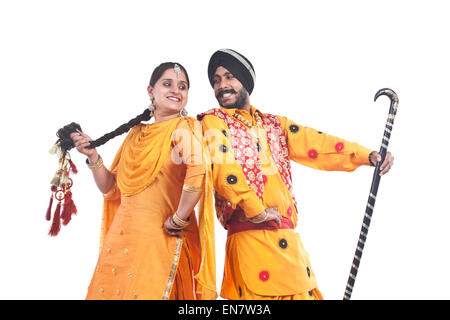 Sikh couple standing back to back Stock Photo