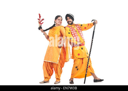Sikh couple standing back to back Stock Photo