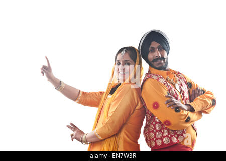 Portrait of Sikh couple standing back to back Stock Photo