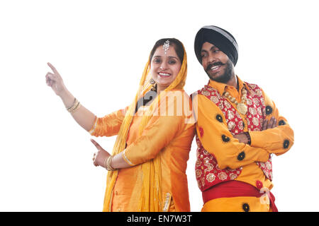 Portrait of Sikh couple standing back to back Stock Photo