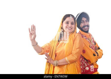 Portrait of Sikh couple standing back to back Stock Photo