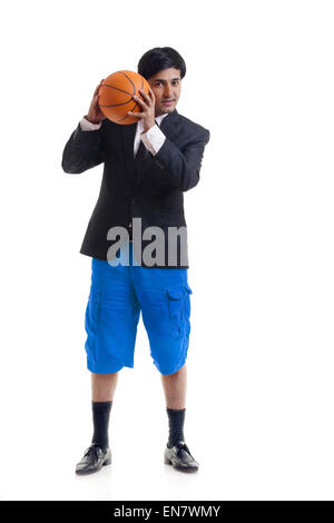Portrait of young man holding basketball