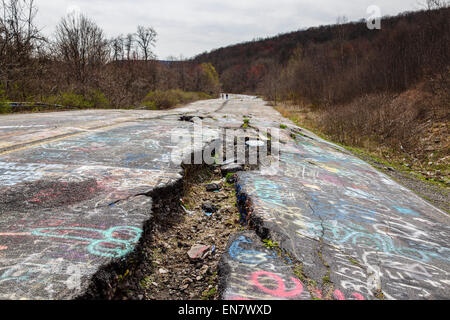 Subsidence cracks on Route 61 or Graffiti Highway in Centralia, PA where a mine fire that began in 1962 continues to burn to this day. Stock Photo