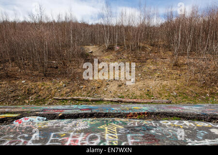 Subsidence cracks on Route 61 or Graffiti Highway in Centralia, PA where a mine fire that began in 1962 continues to burn to this day. Stock Photo