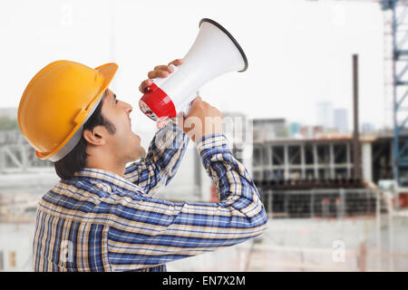 Building Contractor shouting through megaphone Stock Photo