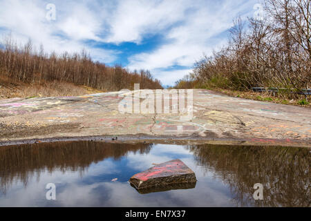 Subsidence cracks on Route 61 or Graffiti Highway in Centralia, PA where a mine fire that began in 1962 continues to burn to this day. Stock Photo