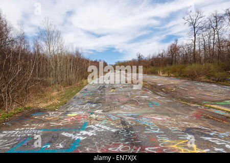 Subsidence cracks on Route 61 or Graffiti Highway in Centralia, PA where a mine fire that began in 1962 continues to burn to this day. Stock Photo