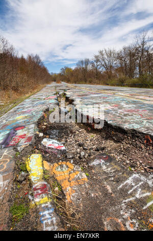 Subsidence cracks on Route 61 or Graffiti Highway in Centralia, PA where a mine fire that began in 1962 continues to burn to this day. Stock Photo