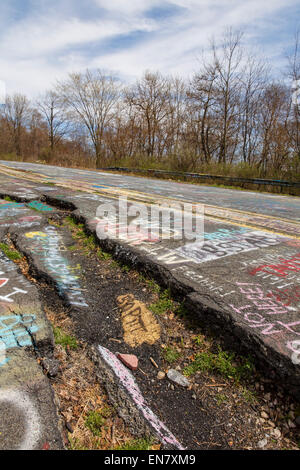 Subsidence cracks on Route 61 or Graffiti Highway in Centralia, PA where a mine fire that began in 1962 continues to burn to this day. Stock Photo