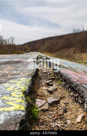 Subsidence cracks on Route 61 or Graffiti Highway in Centralia, PA where a mine fire that began in 1962 continues to burn to this day. Stock Photo