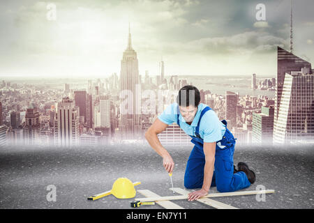 Composite image of repairman fixing screw on plank Stock Photo