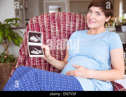 Pregnant woman looking at ultrasound scans Stock Photo