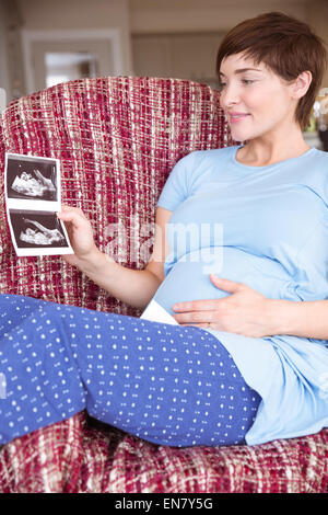 Pregnant woman looking at ultrasound scans Stock Photo