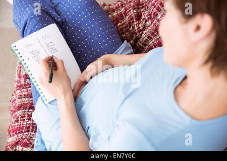 Pregnant woman looking at ultrasound scans Stock Photo