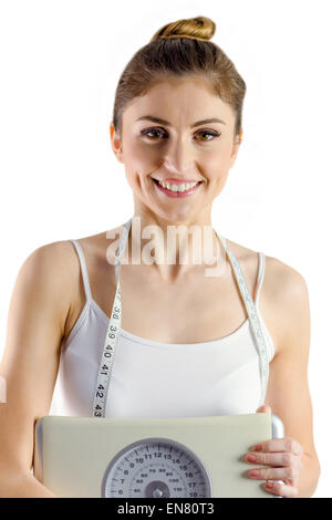 Slim woman holding scales and measuring tape Stock Photo