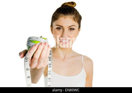 Slim woman holding apple and measuring tape Stock Photo