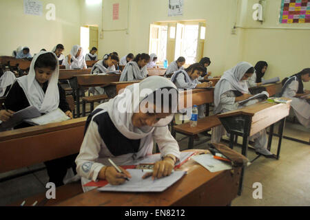 Intermediate students solve examination papers during Annual Examination 2015 at an examination hall as the Intermediate Examinations have been started under regional education board in Hyderabad on Wednesday, April 29, 2015. Stock Photo