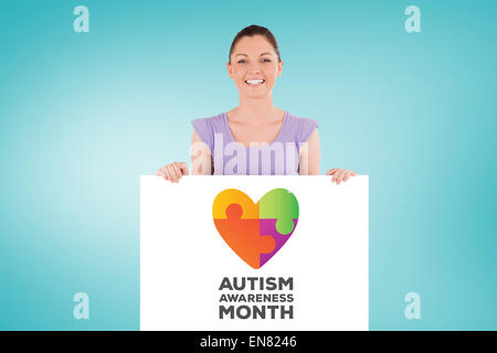 Composite image of portrait of a charming woman posing behind a billboard while standing Stock Photo