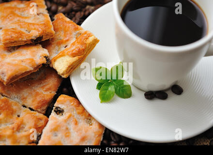 Cup of coffee and tasty cookie with coffee leaf Stock Photo
