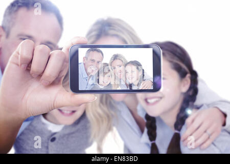 Composite image of hand holding smartphone showing Stock Photo