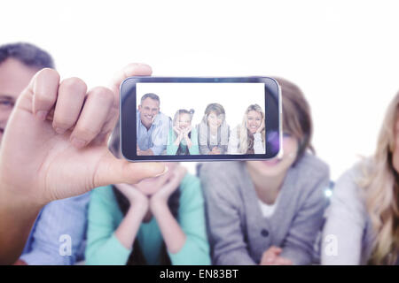 Composite image of hand holding smartphone showing Stock Photo