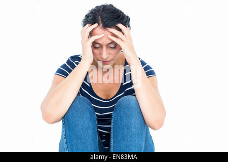 Unhappy woman sitting on the floor Stock Photo