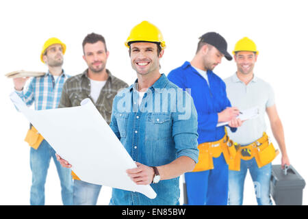 Composite image of happy architect holding blueprint in house Stock Photo