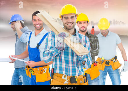 Composite image of construction worker carrying wooden planks Stock Photo