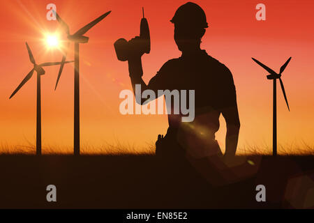 Composite image of carpenter holding cordless drill over white background Stock Photo