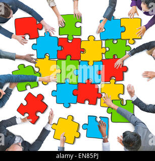 Group of People Forming Jigsaw Puzzles Stock Photo