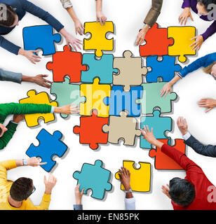 Group of People Forming Jigsaw Puzzles Stock Photo