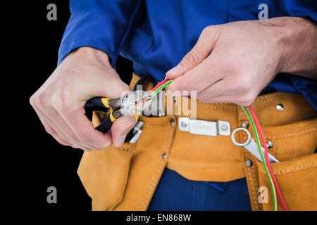Composite image of electrician cutting wires Stock Photo