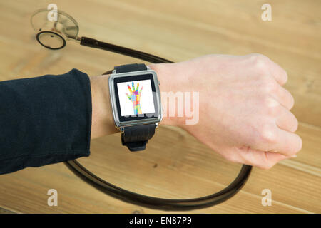 Composite image of businesswoman with smart watch on wrist Stock Photo