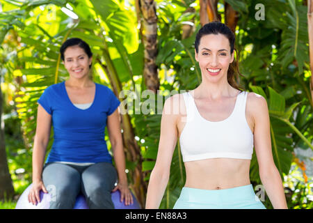 Smiling woman and her trainer looking at camera Stock Photo