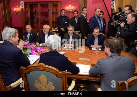 Photographers capture U.S. Secretary of State John Kerry - flanked by State Department Chief of Staff Jon Finer and Under Secretary of State for Political Affairs Wendy Sherman - sitting across from Iranian Foreign Minister Javad Zarif, Dr. Ali Akbar Salehi, the Vice President of Iran for Atomic Energy and President of the Atomic Energy Organization of Iran, and other advisers on March 29, 2015, in Lausanne, Switzerland, before resuming negotiations about the future of Iran's nuclear program. Stock Photo