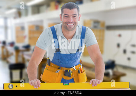 Composite image of worker using spirit level Stock Photo