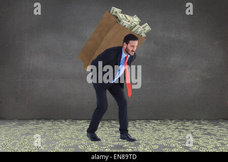 Composite image of businessman carrying bag of dollars Stock Photo