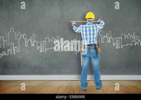 Composite image of rear view of construction worker using measure tape Stock Photo