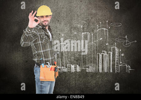Composite image of smiling handyman gesturing okay Stock Photo