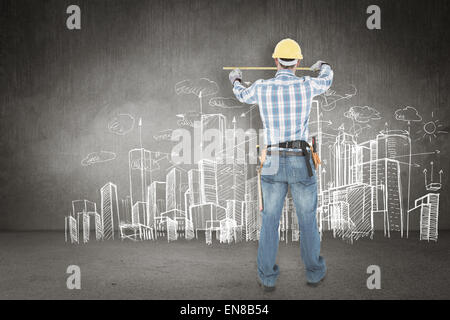 Composite image of rear view of construction worker using measure tape Stock Photo