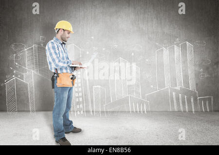 Composite image of full length of repairman using laptop Stock Photo