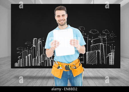 Composite image of construction worker showing blank paper on clipboard Stock Photo