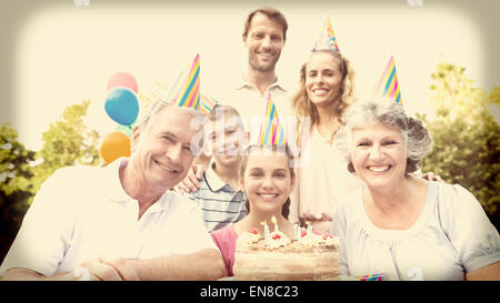 Cheeful family smiling at camera at birthday party Stock Photo