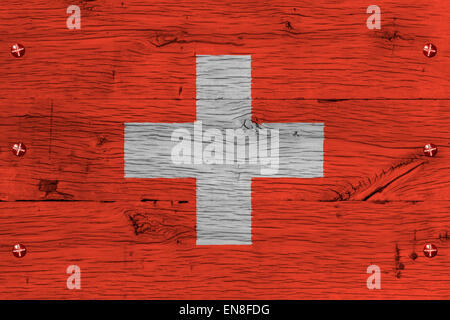 Switzerland,  Swiss Federation national flag. Painting is colorful on wood of old train carriage. Fastened by screws or bolts. Stock Photo