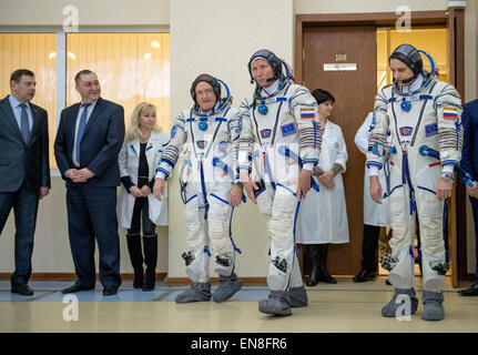 Expedition 43 NASA Astronaut Scott Kelly, left, Russian cosmonaut Gennady Padalka of the Russian Federal Space Agency (Roscosmos), center, and Russian Cosmonaut Mikhail Kornienko of Roscosmos depart a changing room where they donned their Russian sokol suits for their second day of qualification exams Thursday, March 5, 2015 at the Gagarin Cosmonaut Training Center (GCTC) Soyuz training facility in Star City, Russia. The trio is preparing for launch to the International Space Station in their Soyuz TMA-16M spacecraft from the Baikonur Cosmodrome in Kazakhstan March 28, Kazakh time. As the one- Stock Photo