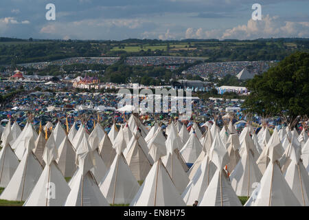 GLASTONBURY, UK - JUNE 28: Tipi tents at Glastonbury Festival on 28th June, 2014 at Pilton Farm, Somerset. Stock Photo