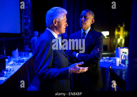 President Barack Obama speaks with former President Bill Clinton backstage prior to delivering remarks during the Clinton Global Initiative in New York, N.Y., Sept. 23, 2014. Stock Photo