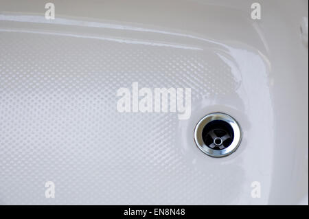 Close up of the drain in a ceramic bath tub Stock Photo