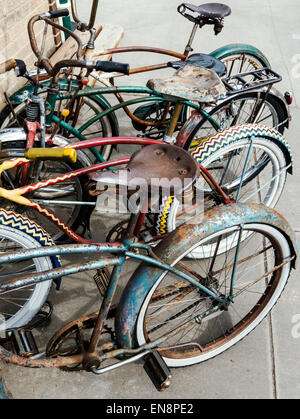 Old antique bicycles parked outside Salida Bike Company, downtown historic Salida, Colorado, USA Stock Photo